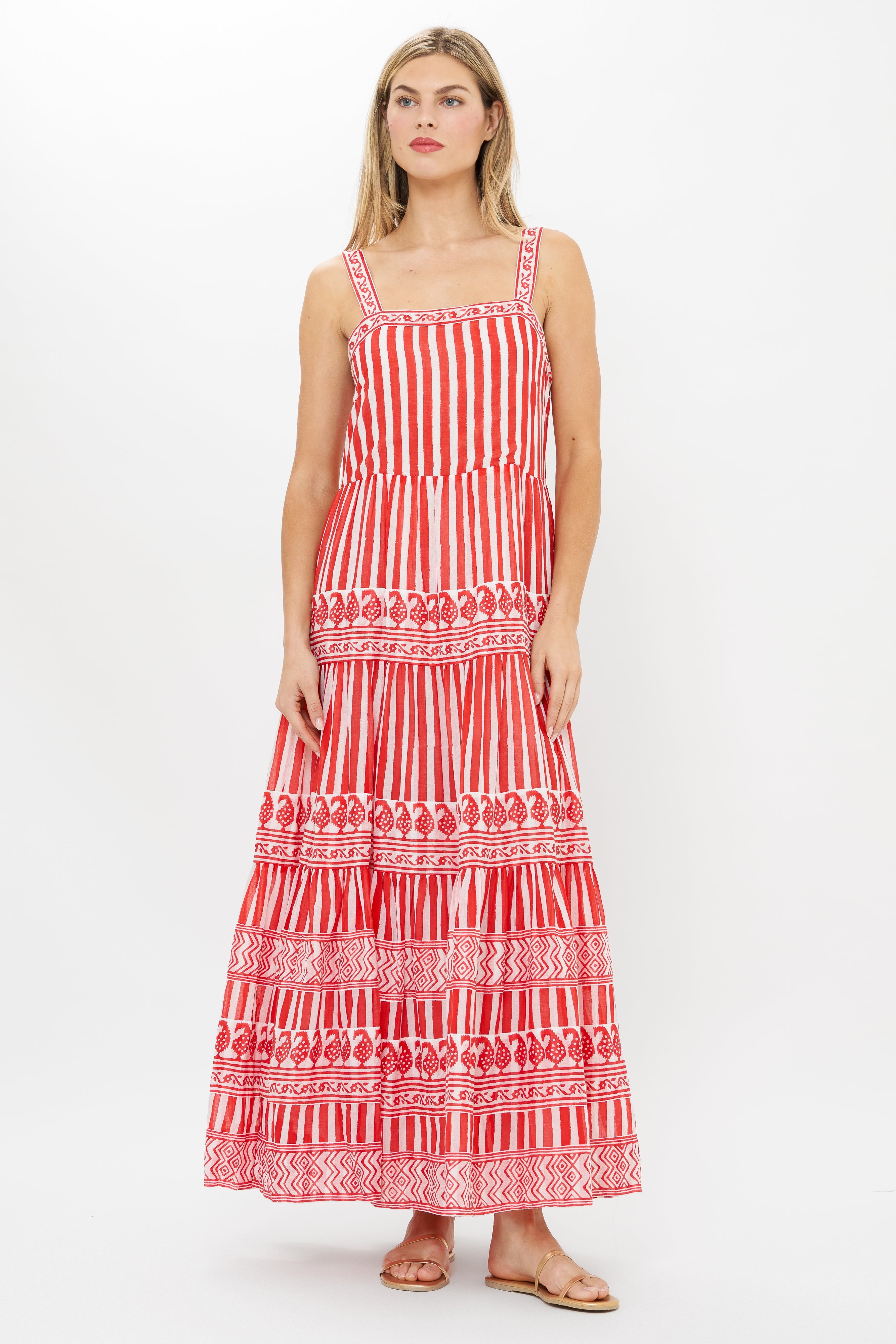 Woman wearing red and white striped maxi dress with geometric patterns and straps