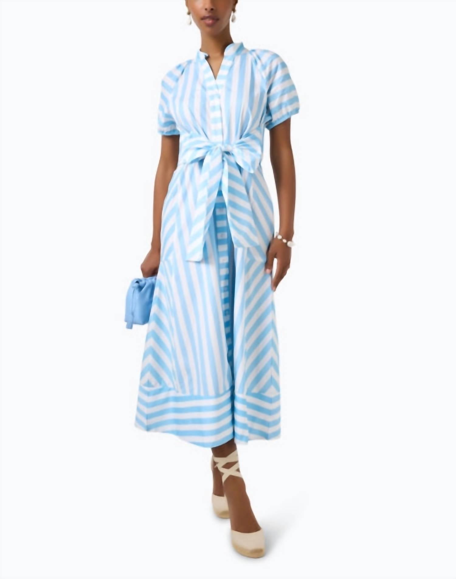 Woman wearing blue and white striped midi dress with tie waist and short sleeves