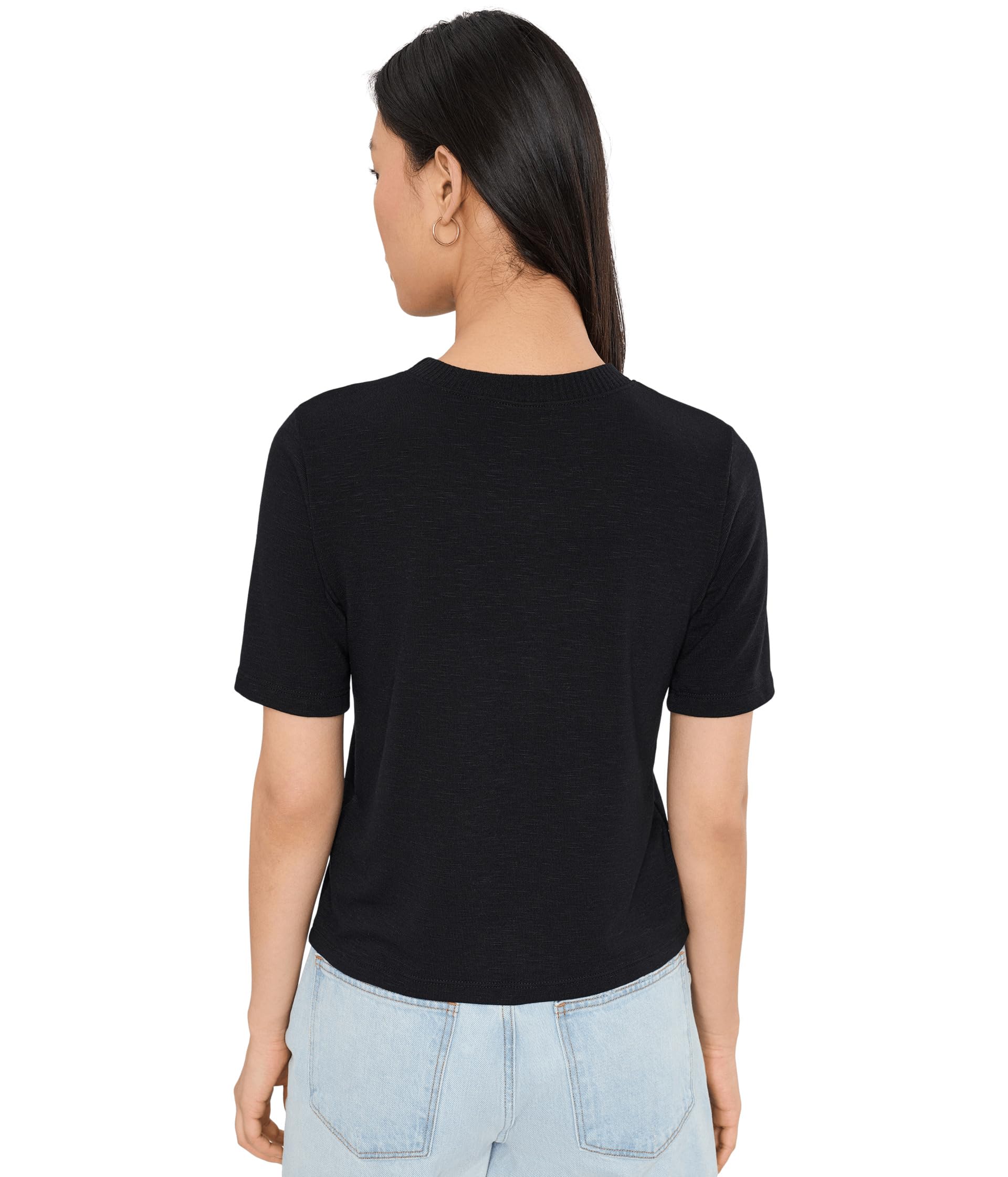 Back view of woman wearing black crew neck t-shirt with light wash jeans