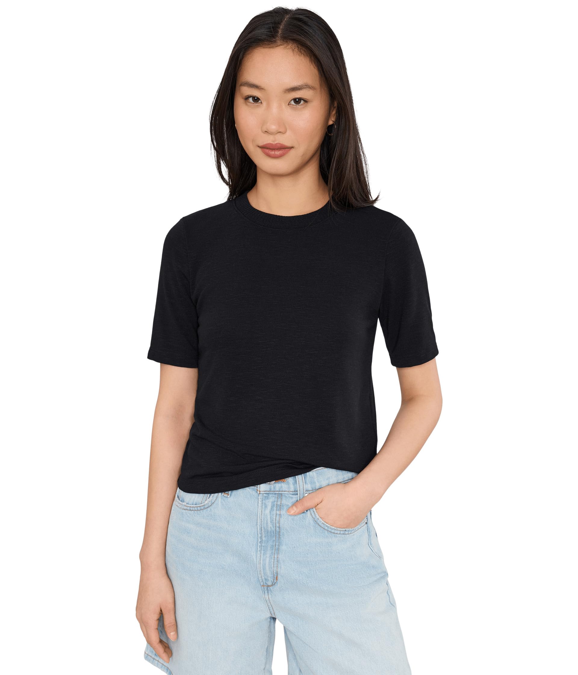 Woman wearing black crew neck short sleeve t-shirt with light blue jeans