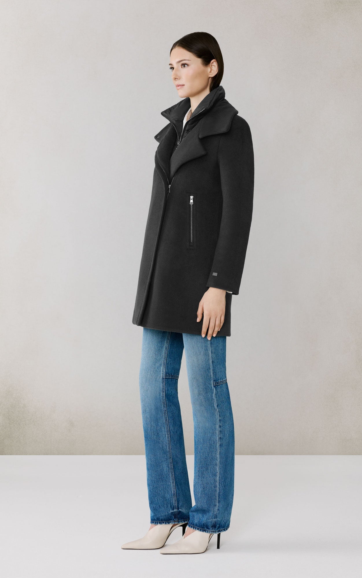Woman wearing black Soia & Kyo Abbi wool coat with zipper details and blue jeans