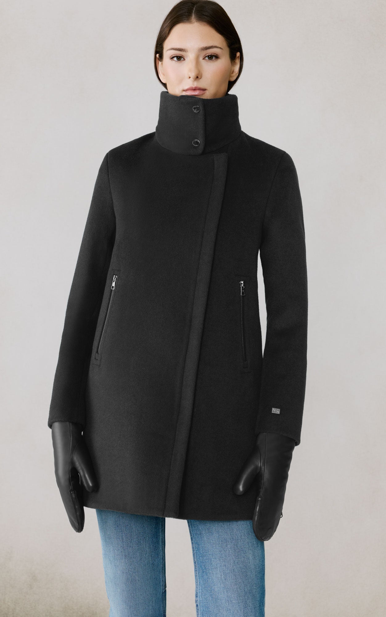 Woman wearing black Soia & Kyo Abbi wool coat with high collar and zipper pockets