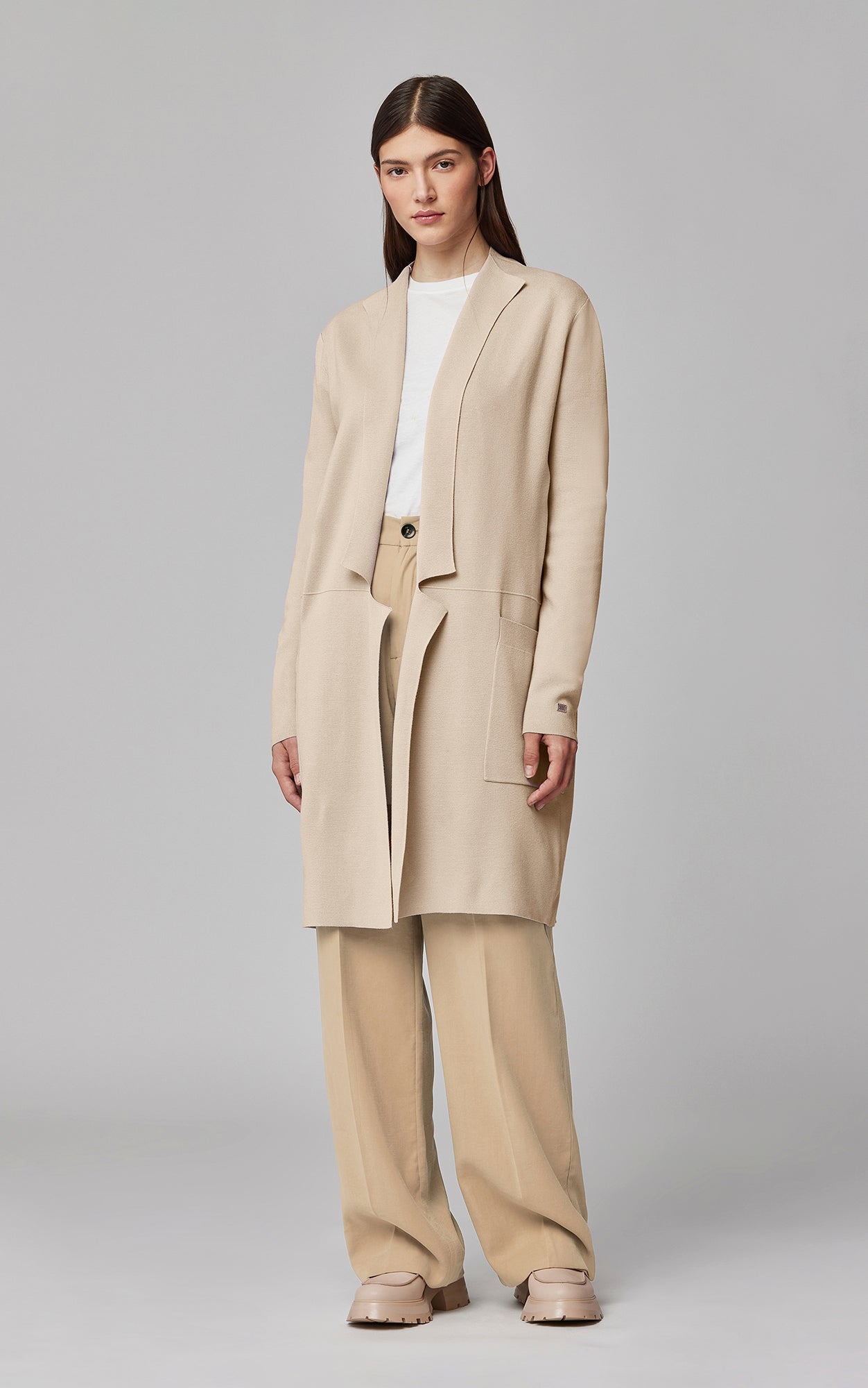 Woman wearing Soia & Kyo Benela cardigan in almond mist with matching wide-leg pants