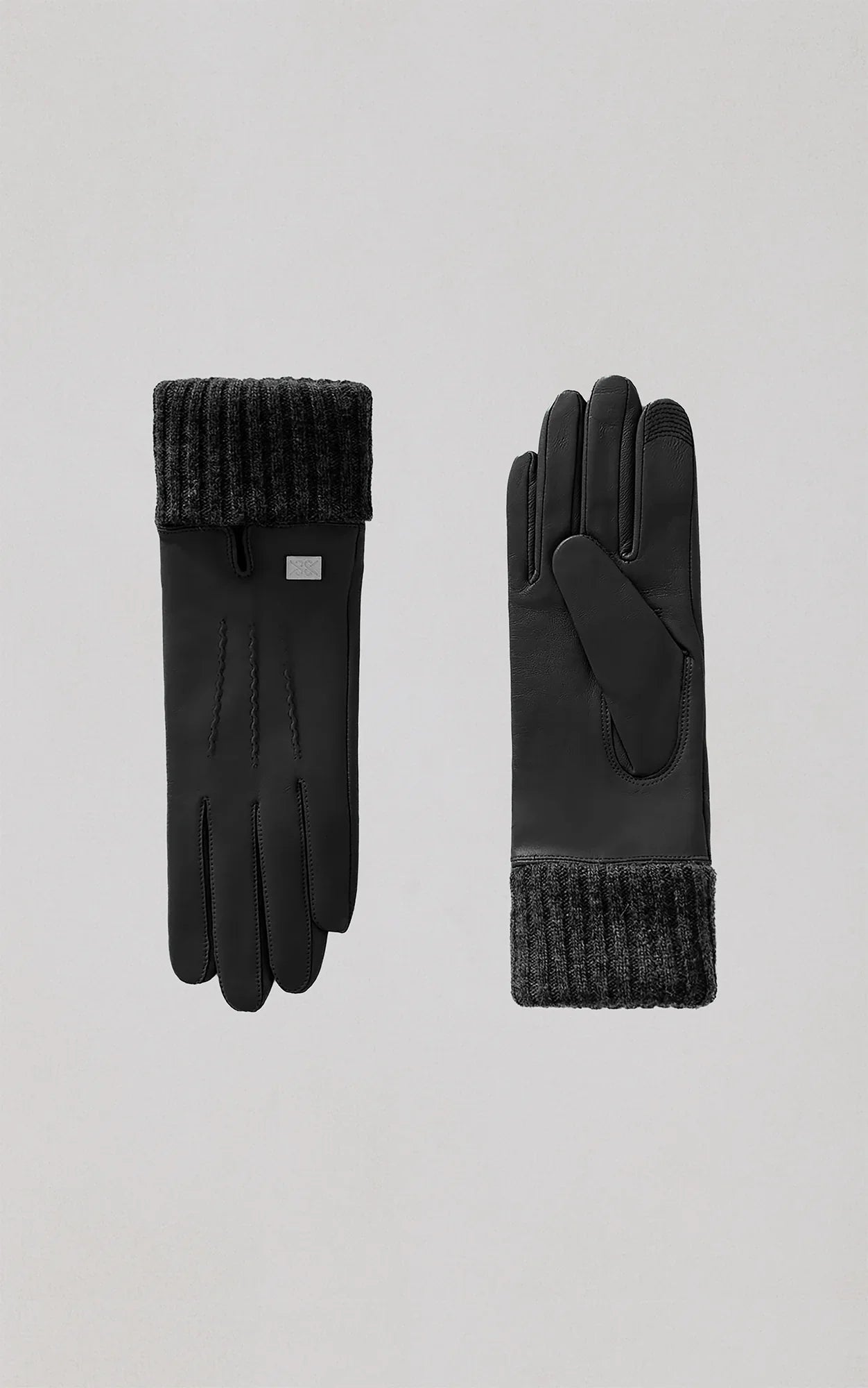 Black leather gloves with ribbed knit cuffs and decorative stitching details