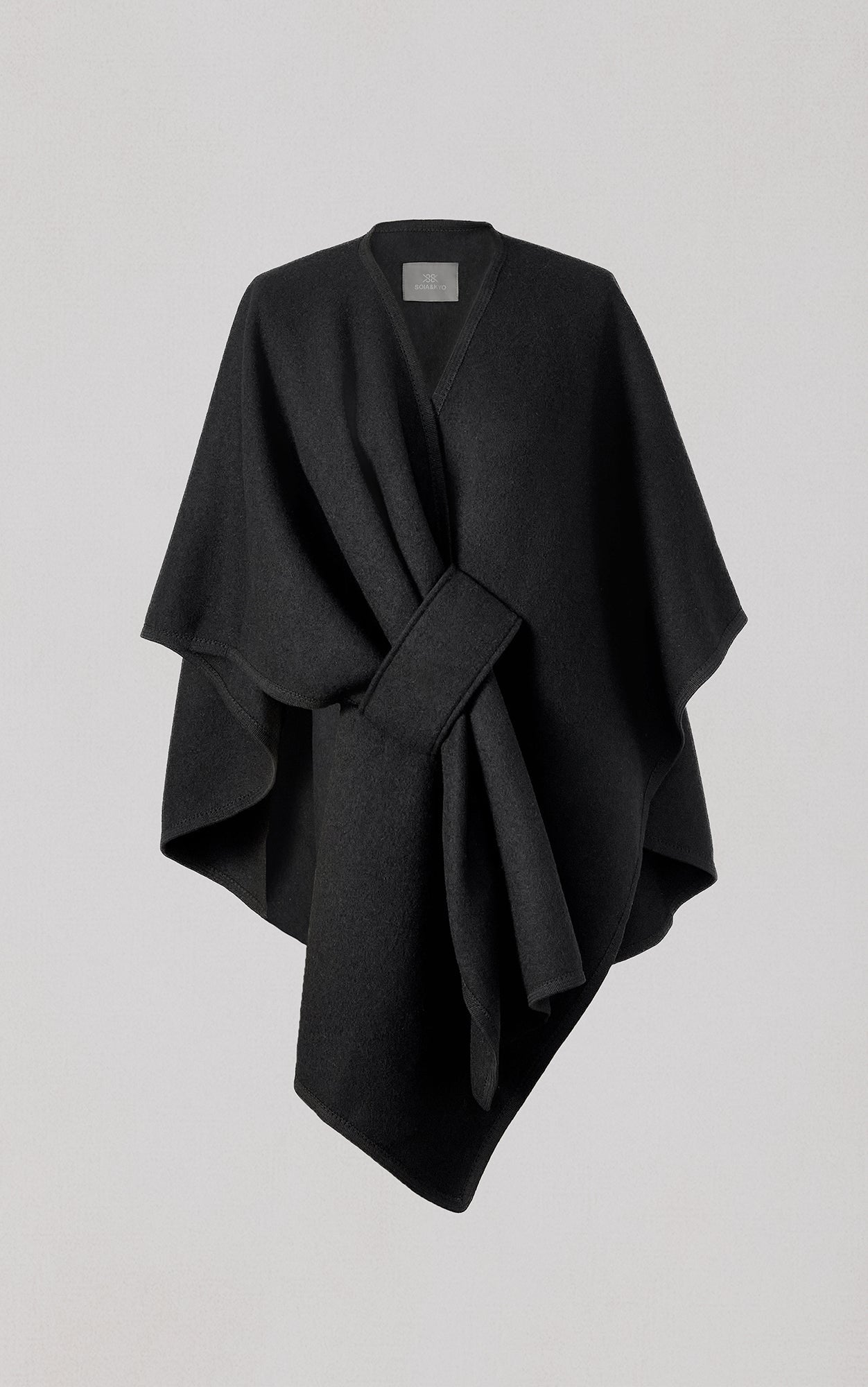 Black wool scarf with tie belt draped asymmetrically against neutral background