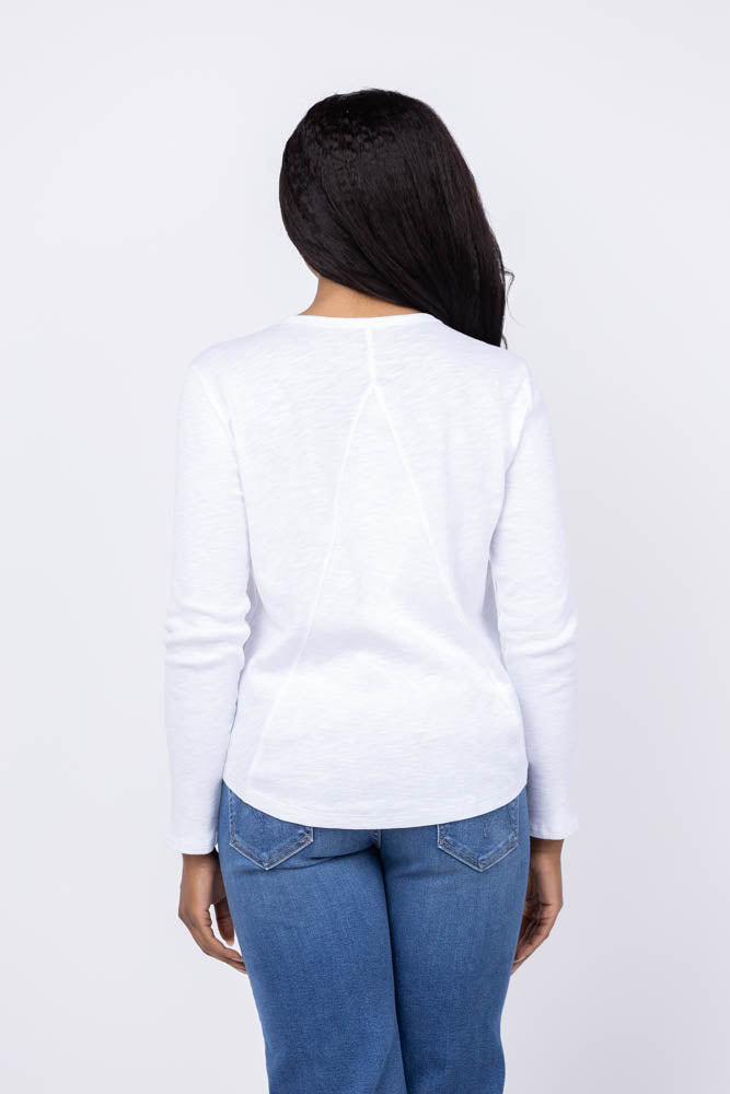 Back view of woman wearing white long sleeve rib tee with blue jeans