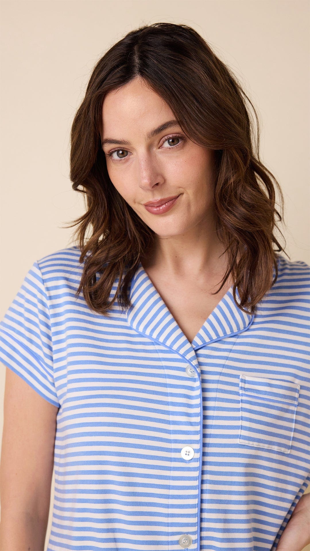 Woman wearing blue and white striped short-sleeve button-front Pima knit pajama top with chest pocket
