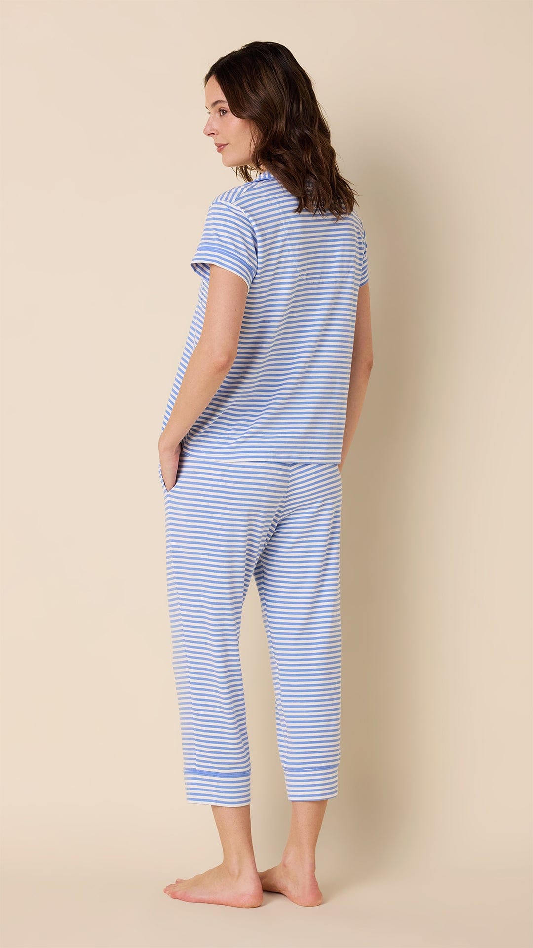 Woman wearing blue and white striped Pima knit capri pajama set, back view