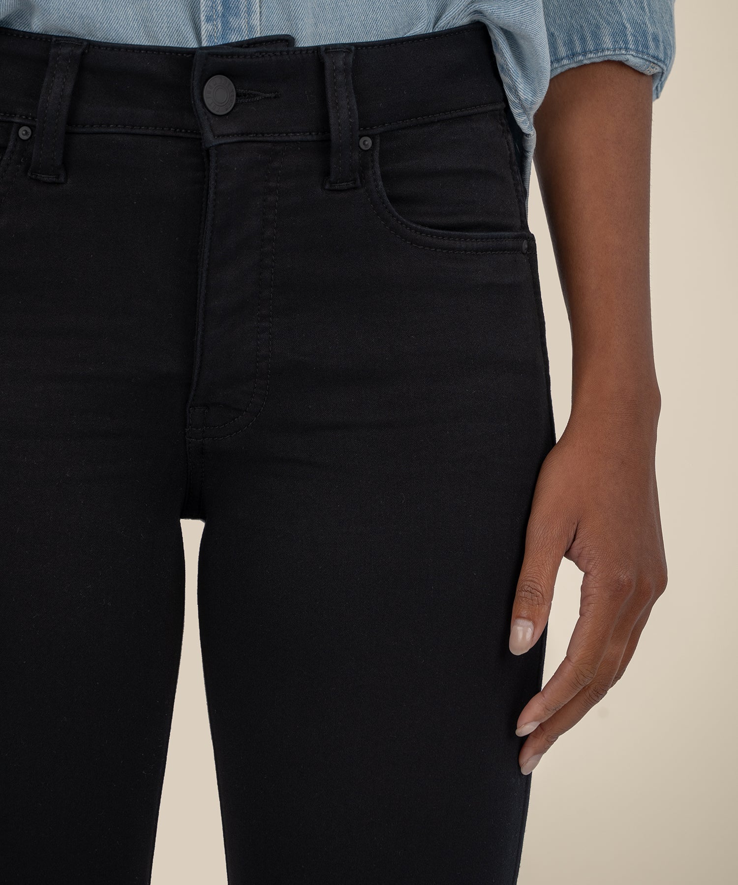 Black high-rise bootcut jeans with silver button detail and classic five-pocket styling