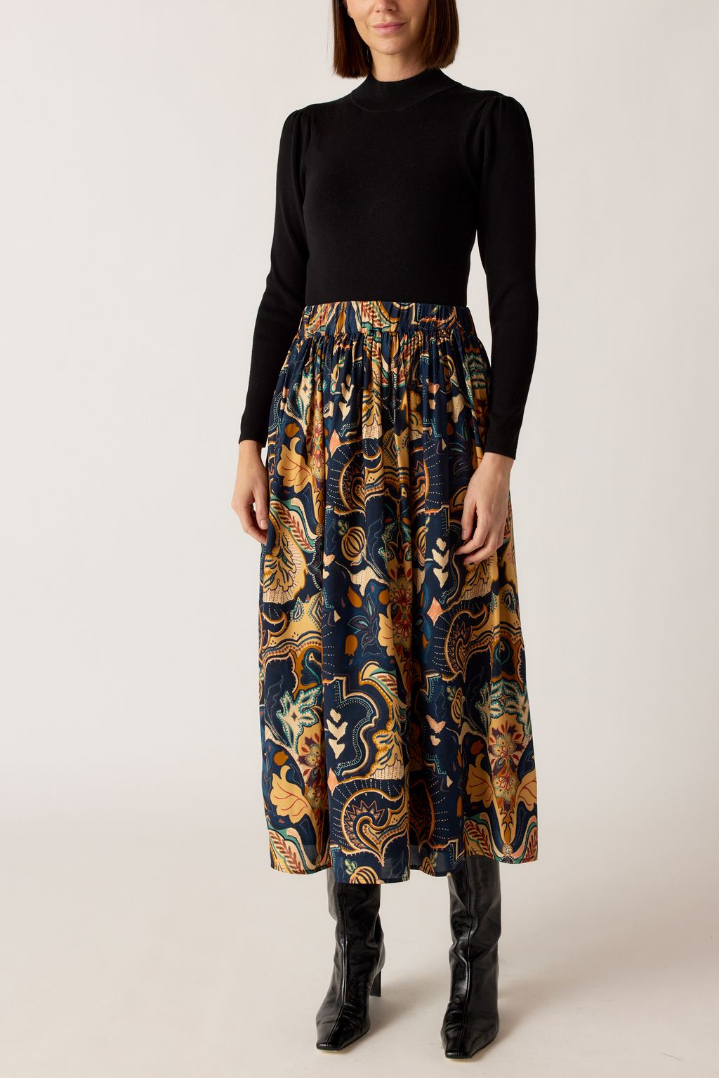 Marie Oliver Gracie Skirt in Saddle paisley print paired with black mock-neck top and boots
