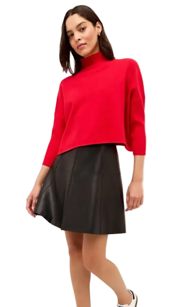 Woman wearing red Marie Oliver Claudie popover sweater with black leather mini skirt