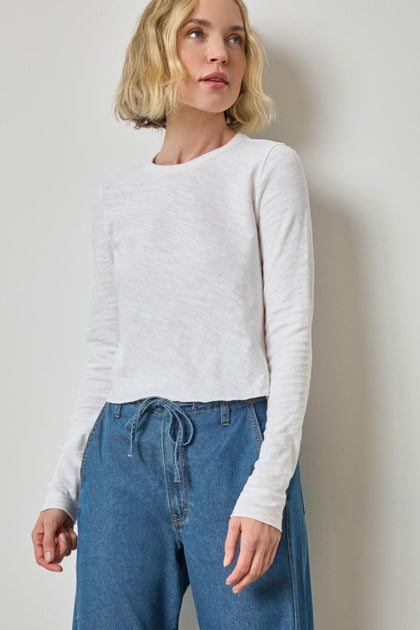 Woman wearing white long sleeve vintage slub top with blue drawstring pants