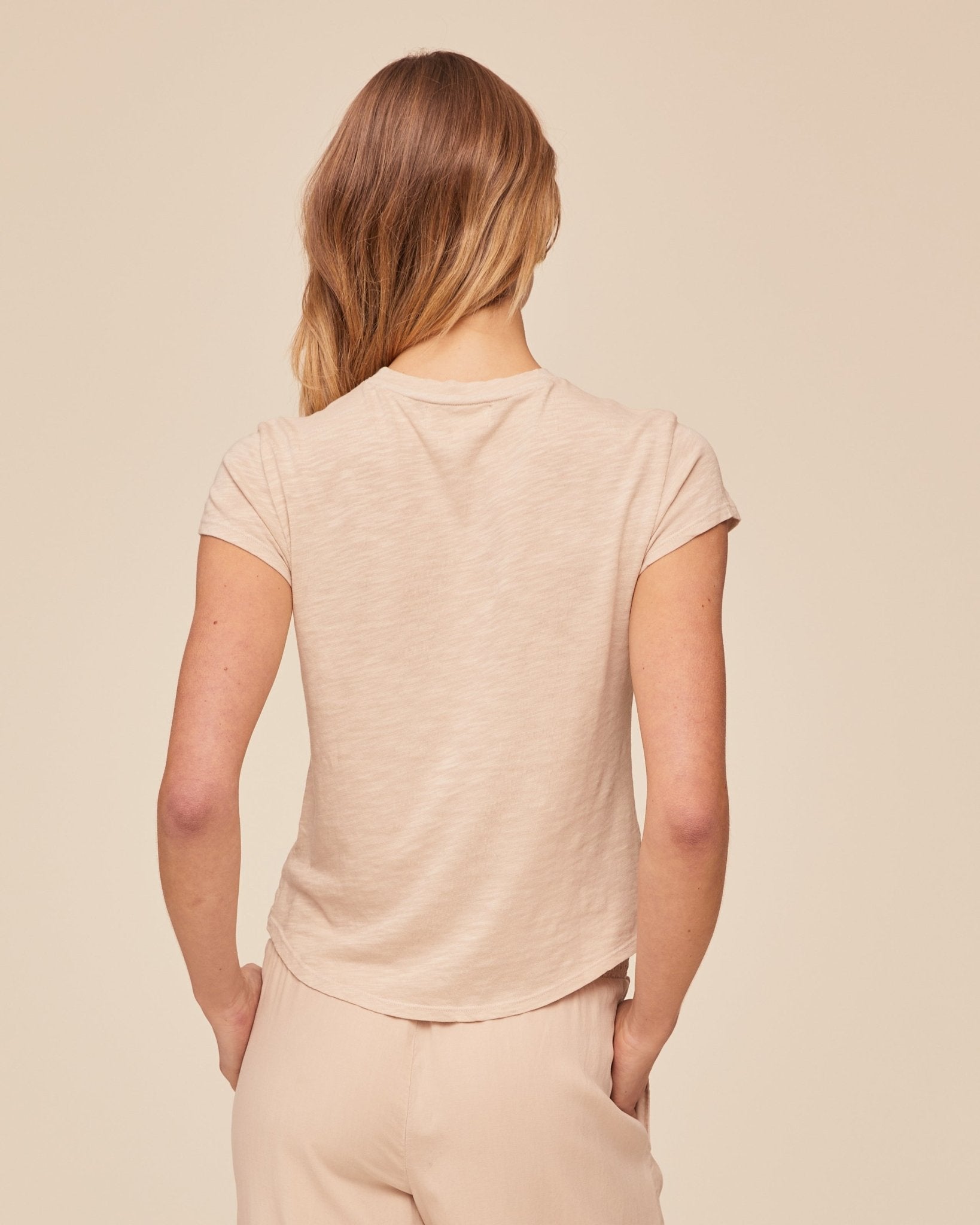 Back view of woman wearing Bella Dahl Baby Crew Tee in Linen Sand color