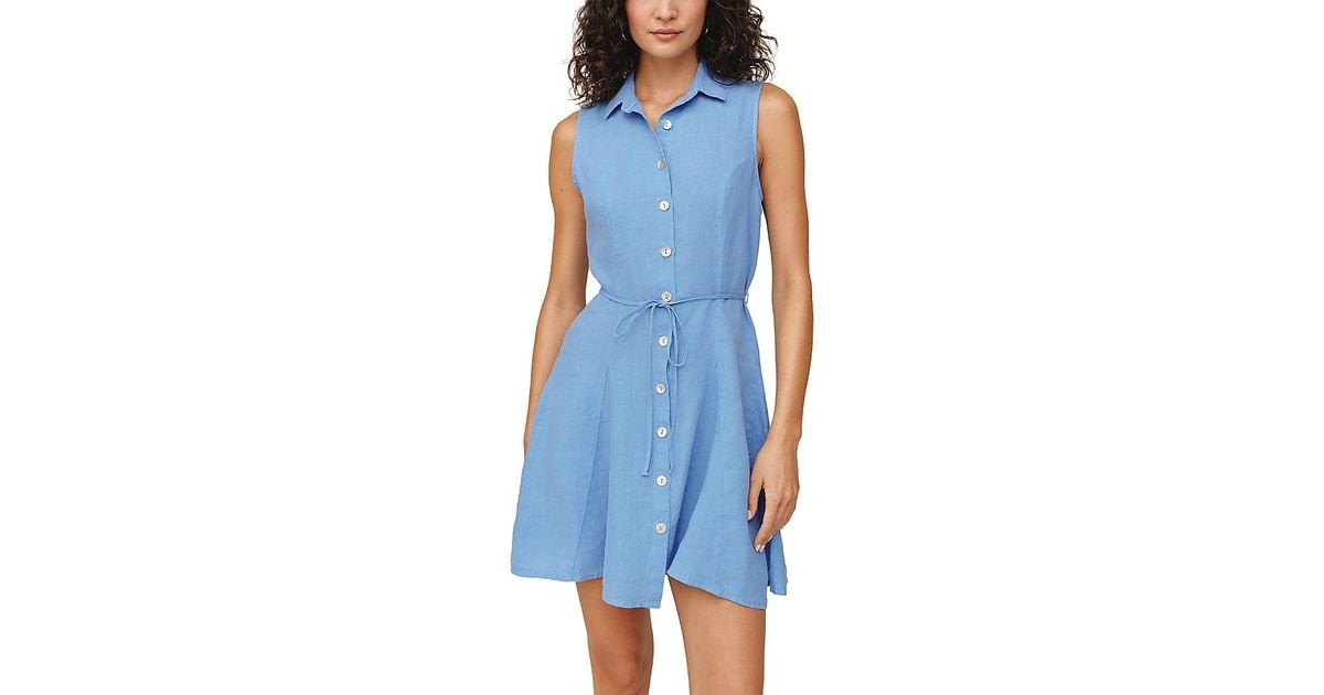 Woman wearing sleeveless ocean blue button-front shirt dress with tie waist belt