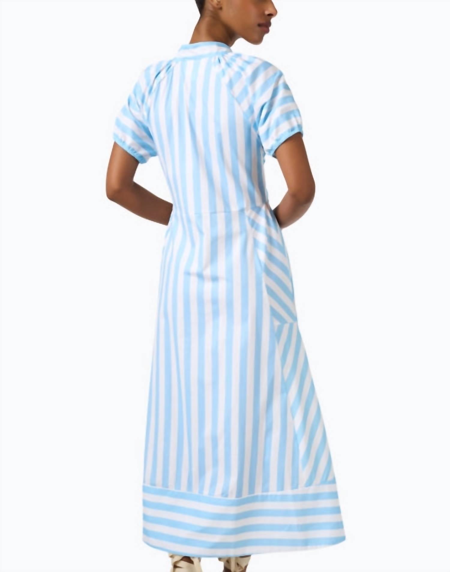 Woman wearing blue and white striped maxi dress with short sleeves