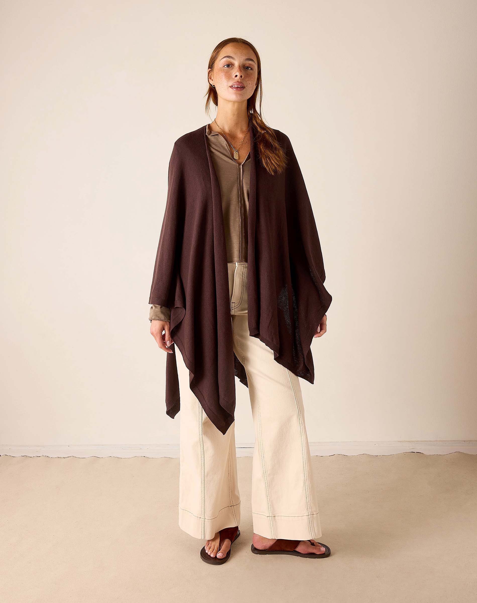 Woman wearing Mer-Sea Charleston Wrap in chocolate brown over beige top and cream wide-leg pants