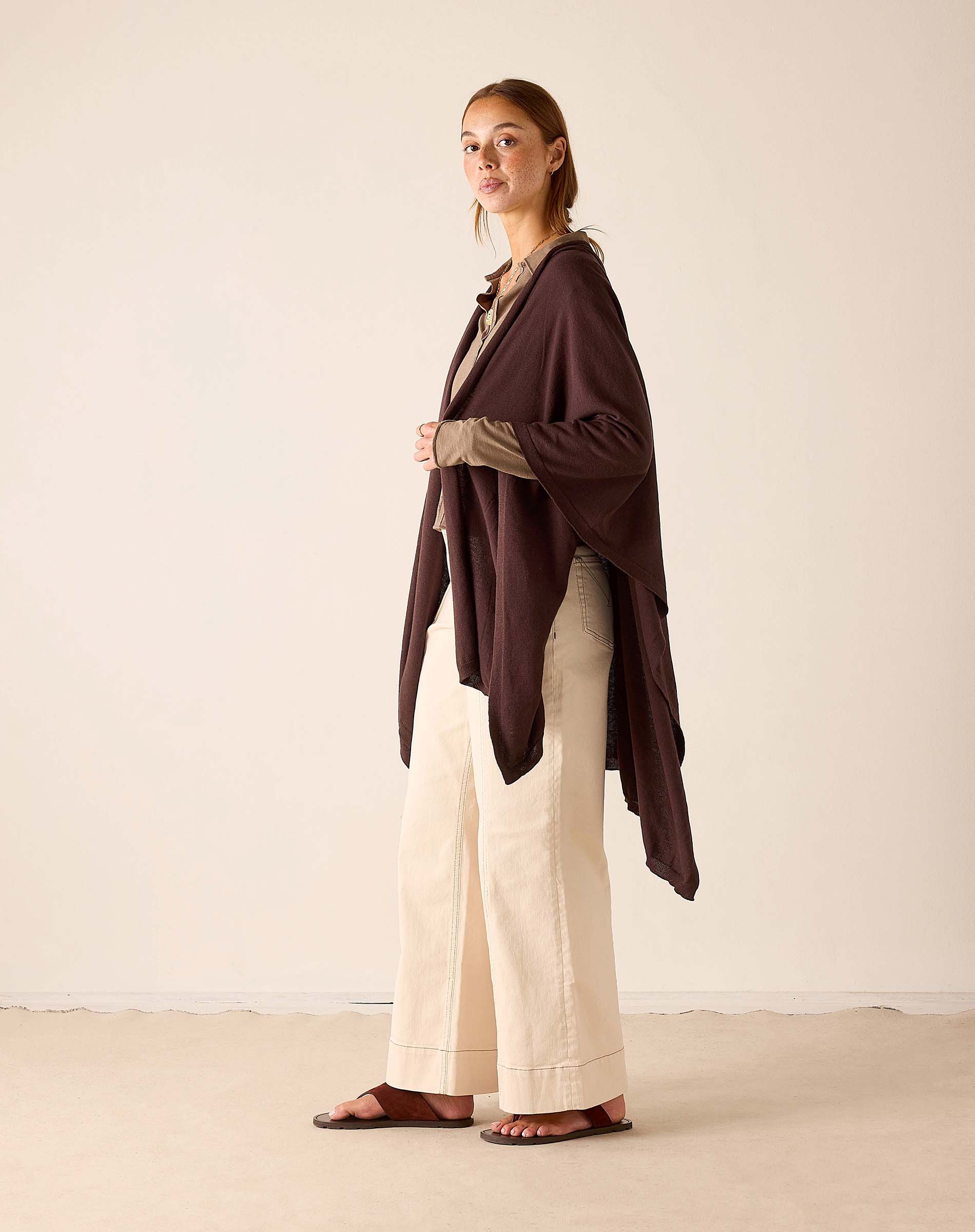 Mer-Sea & Co. Charleston Wrap in chocolate brown draped over model with cream wide-leg pants