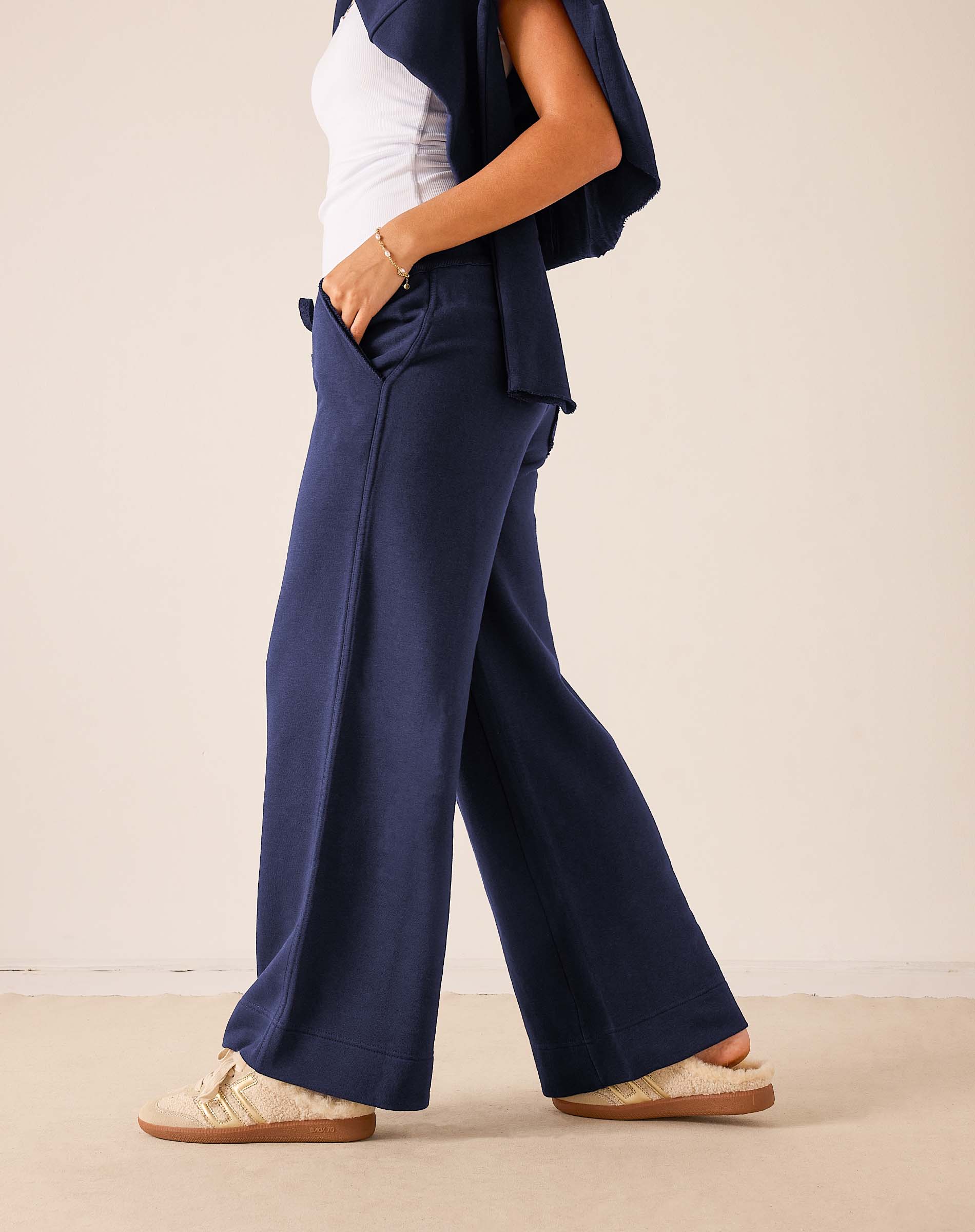 Mer-Sea Frenchie Wide Leg Pant in cadet blue shown from side angle with sneakers