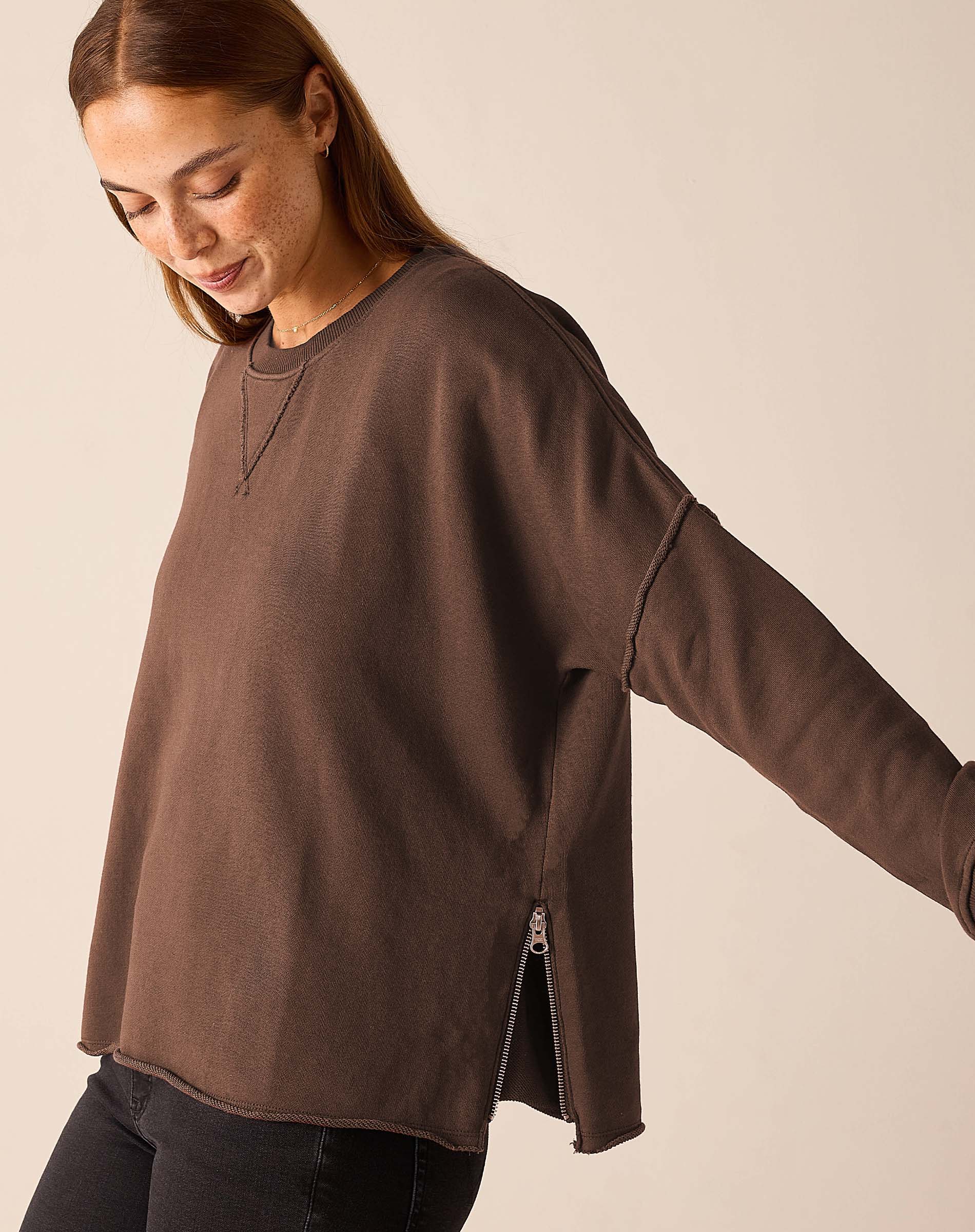 Woman wearing Mer-Sea Frenchie Zip Side Crewneck sweatshirt in espresso brown with side zipper detail