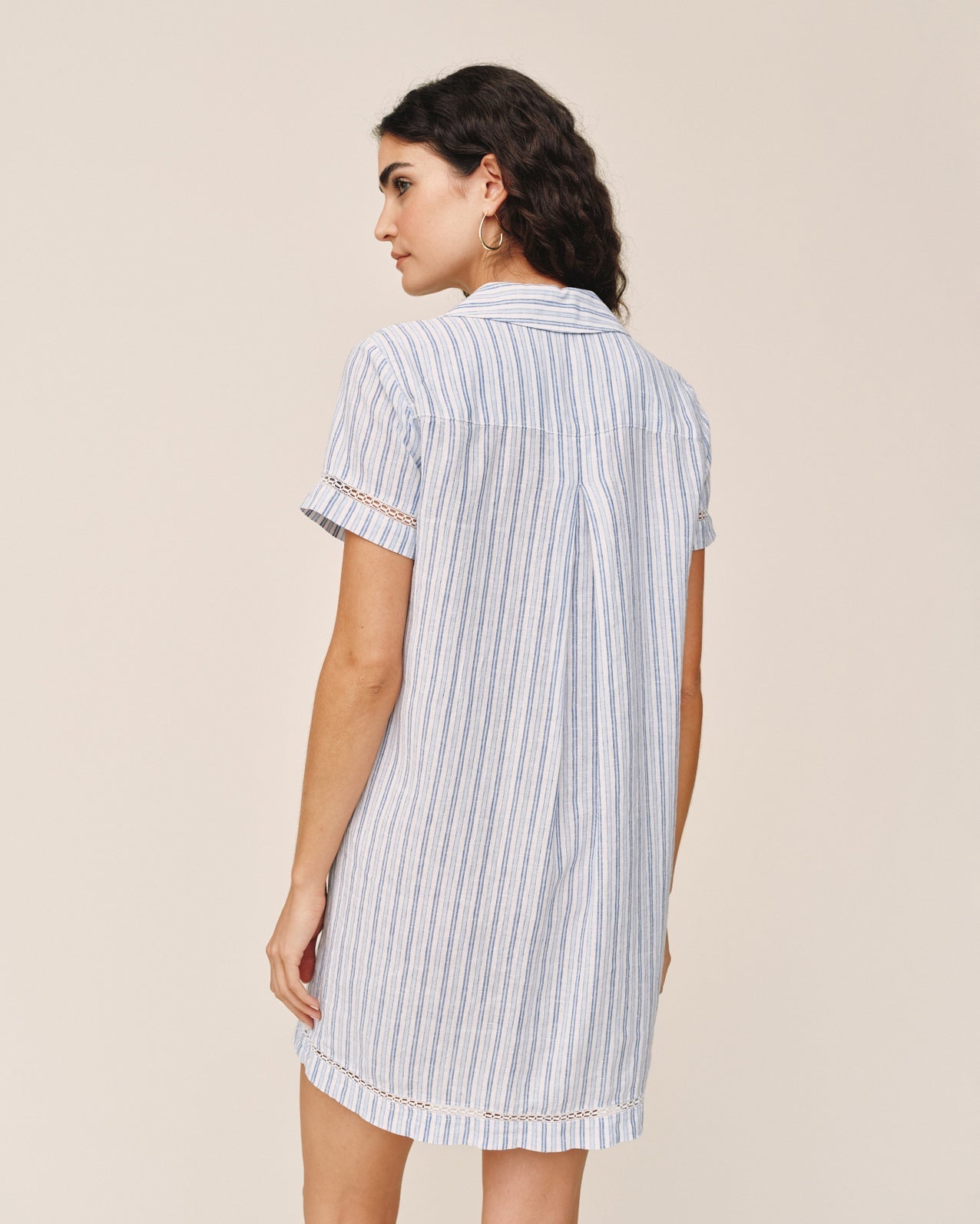 Woman wearing Bella Dahl short sleeve striped shirt dress in ocean blue stripe pattern