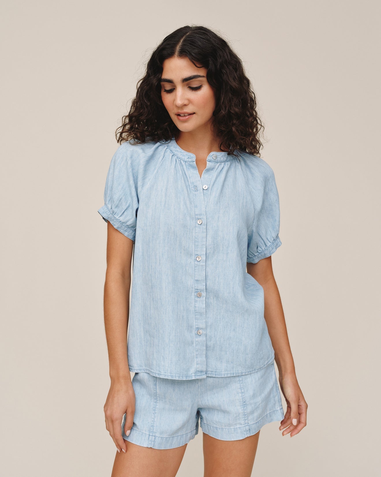 Woman wearing light blue short sleeve raglan shirt with matching shorts in sun bleached wash