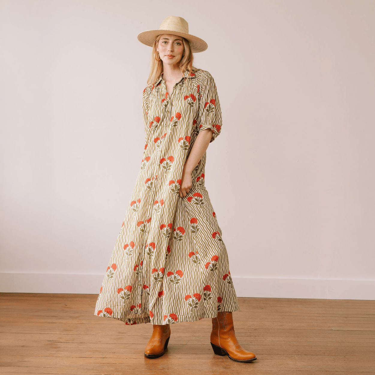 Sunshine Tienda Wavy Stripe Oasis Dress in floral block print with cowboy boots and straw hat