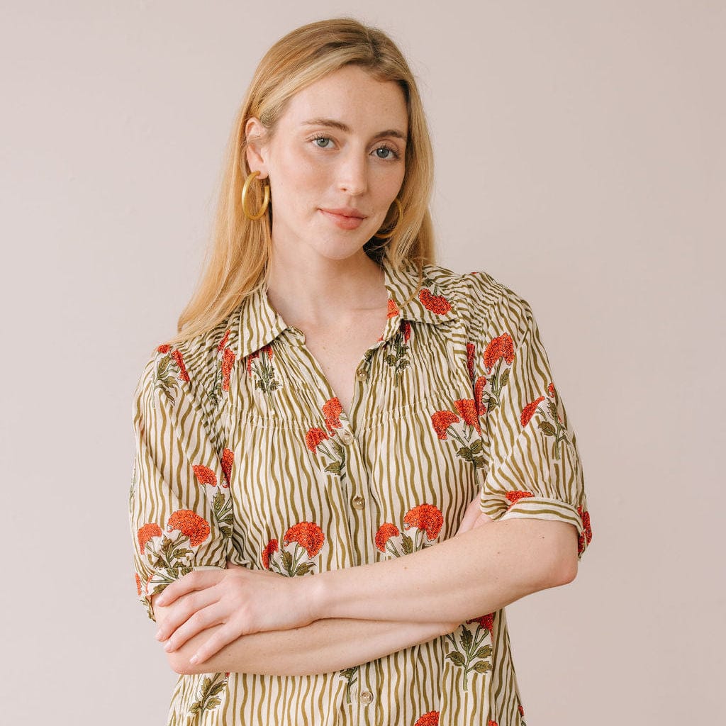 Woman wearing Sunshine Tienda Wavy Stripe Oasis Dress with red floral and olive stripe pattern