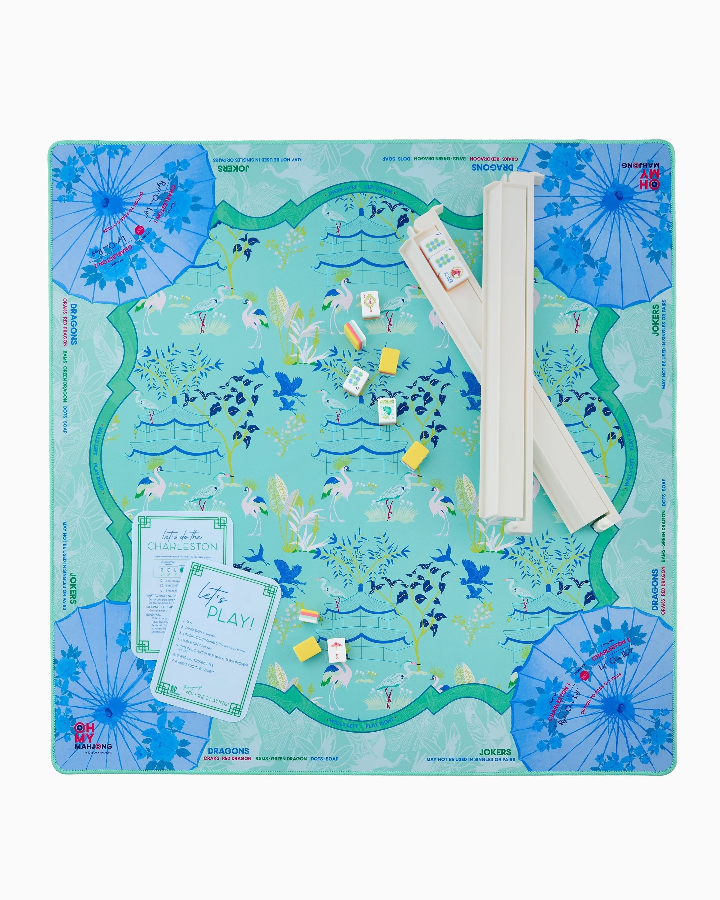 Oh My Mahjong Veranda Mat with teal chinoiserie heron pattern, tiles, and racks displayed